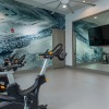 fitness center with rows of treadmills and modern style flooring