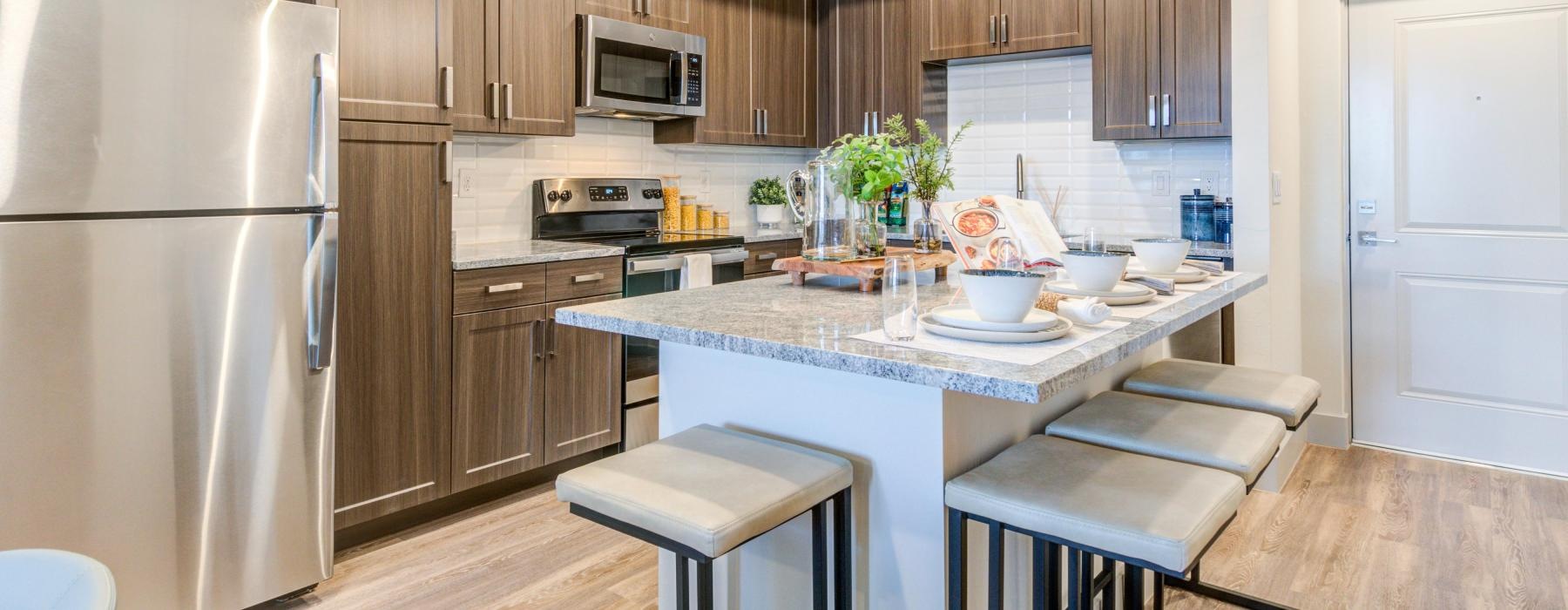 a kitchen with a bar stool and a table