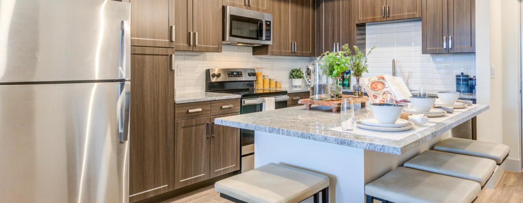 a kitchen with a bar stool and a table