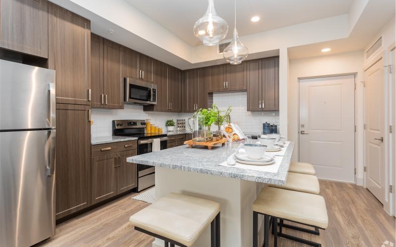 a kitchen with a bar stool and a table