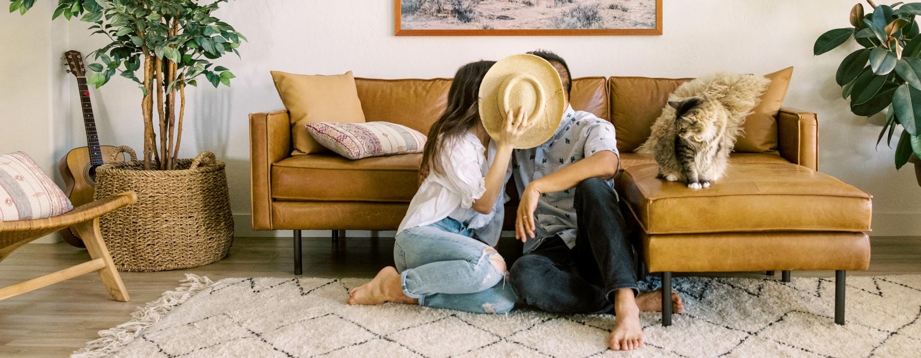 a person and a dog sitting on a couch