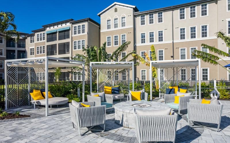 a patio with tables and chairs