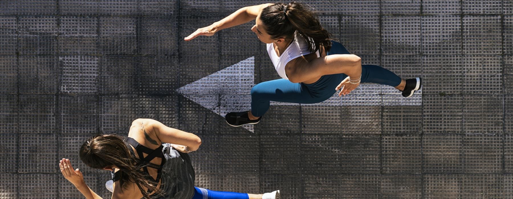 a couple of women jumping in the air